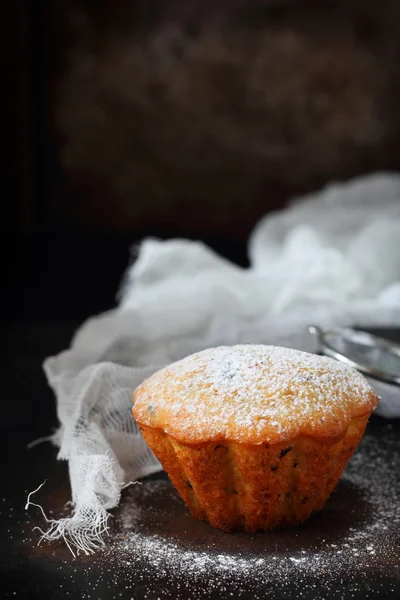 Orange muffin with powdered sugar — Stok fotoğraf