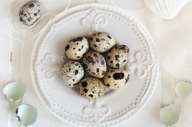 Beyaz bir arka planda beyaz tabakta bıldırcın yumurtası