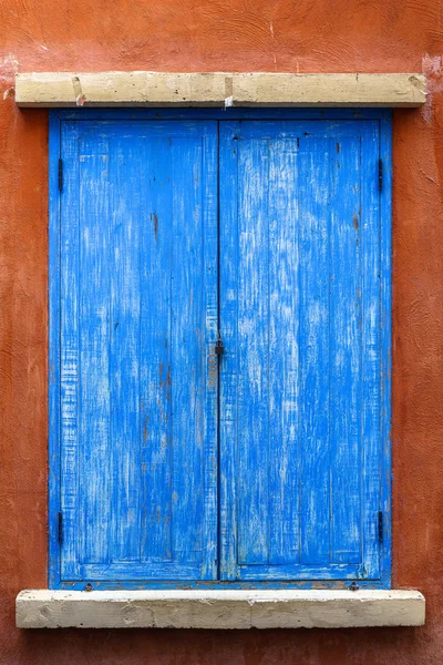 Blaues Holzfenster an roter Wand — Stockfoto