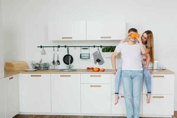 Young couple cooking - man and woman in their kitchen