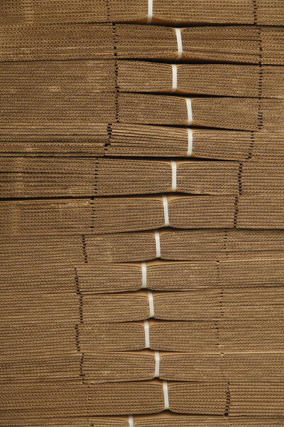 Cardboard pile on corrugated cardboard texture