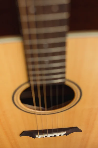 six-string acoustic guitar on a red background