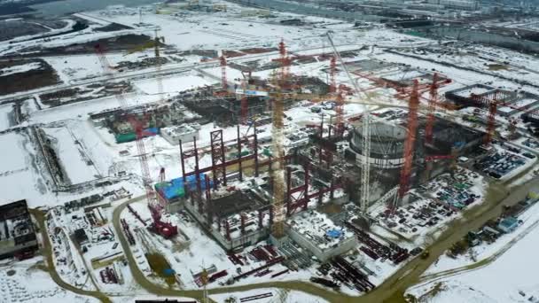 Aerial view of the construction of a nuclear power plant. Creation of nuclear power. Clean, green energy for the future. Winter carbon dioxide emissions. Ecology and pollution of nature. Drone shoot — Stock Video