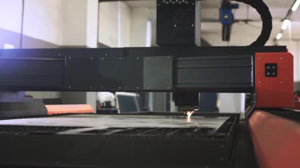 Lasersnijden van metaal. Een industriële machine met een krachtige lichtstraal snijdt een dikke plaat metaal. Metaalbewerking in de fabriek. CNC lasermachine voor het snijden van metalen plaat op industriële vervaardiging. — Stockvideo