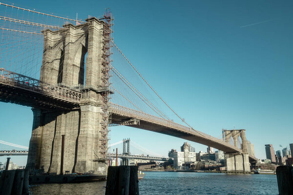 Evening view of the Brooklyn Bridge. New York landmark. Place of visiting tourists.