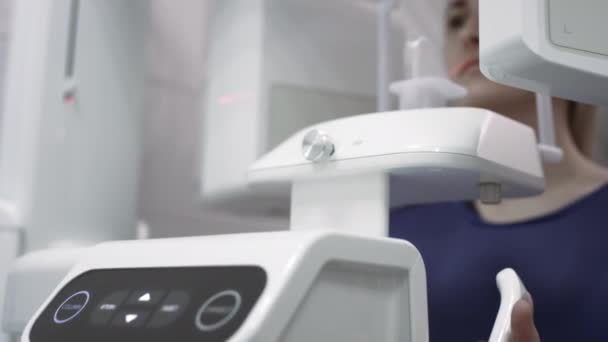 Menina paciente dentro de um scanner 3d panaromaniac de dentes. Equipamento de diagnóstico dispositivo ortoantomográfico para dentes em uma clínica odontológica moderna, MRI. — Vídeo de Stock