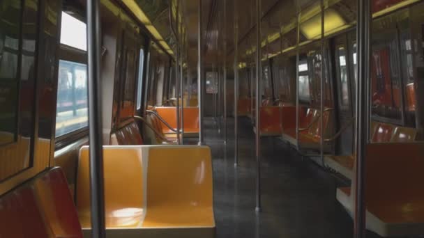 New York United States - 02 08 2019: Empty seats in a subway car. No passengers aboard an in service New York City subway train. Lack of people during a pandemic in public places — Stock Video