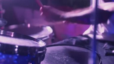 Profesyonel bir erkek sanatçı davul çalar. Müzikal enstrüman kayıt stüdyosunda gece gösterisi. Davulcu çalar ve çalar,