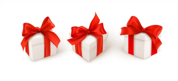 Set of three white gift boxes with red silk ribbon bow isolated on white background. Vector illustration — Wektor stockowy