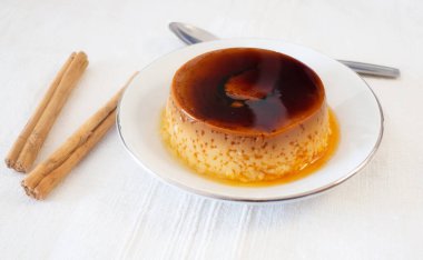 Ev yapımı muhallebi ya da beyaz tabakta puding ve biraz tarçın.