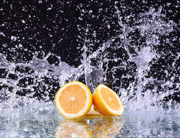 レモンの水のしぶきをマクロ。ジューシーなレモンと水滴 — ストック写真