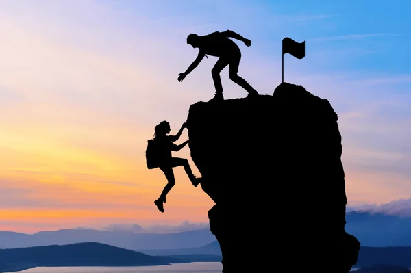 Ortak çalışma ekip çalışması iki kişi adam ve kız yolcuları birbirimize üstüne bir dağcılık takımı, güzel bir günbatımı manzara yardımcı.