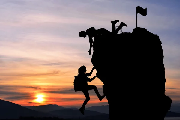 Ortak çalışma ekip çalışması iki kişi adam ve kız yolcuları birbirimize üstüne bir dağcılık takımı, güzel bir günbatımı manzara yardımcı.