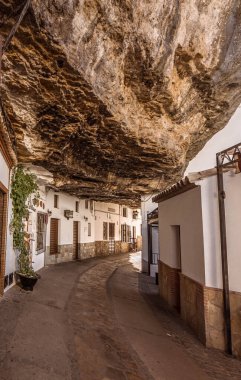  Streets and houses under the mountain of Setenil de las Bodegas, Cadiz.  clipart