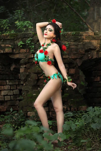 Beautiful woman bikini and vine dress brick wall — Stock Photo, Image