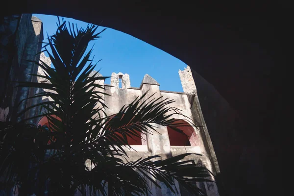 Patio with arches and palm tree in the former monestary Convent de San Bernardino de Siena in Valladolid, Yucatan, Mexico