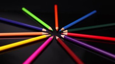 Siyah arkaplandaki renkli kalemler yavaş çekim görüntüleri