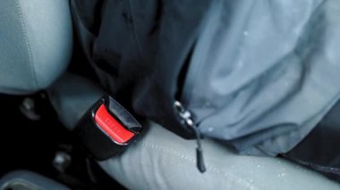 Adam emniyet kemerini takıyor.