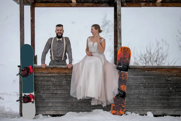 Bride Sits Wooden House Wedding Dress Groom Next Her Snowboards Royalty Free Stock Images