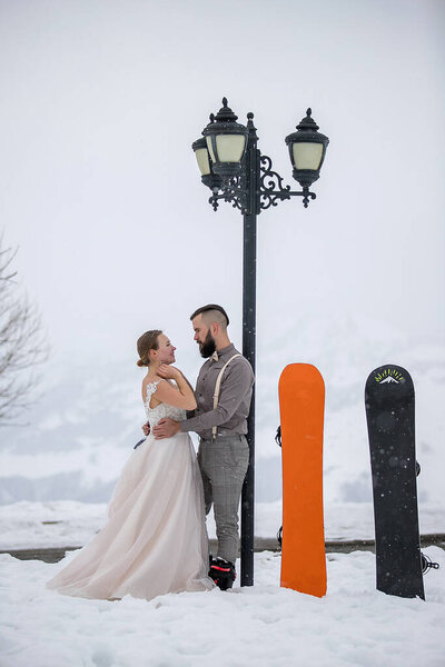 Bride Groom Standing Hugging Winter Lantern Next Snowboards Stock Image