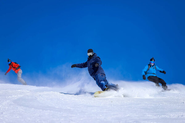 Several Snowboarders Ride Fast Winter Ski Resort Snow Flies Out Royalty Free Stock Photos