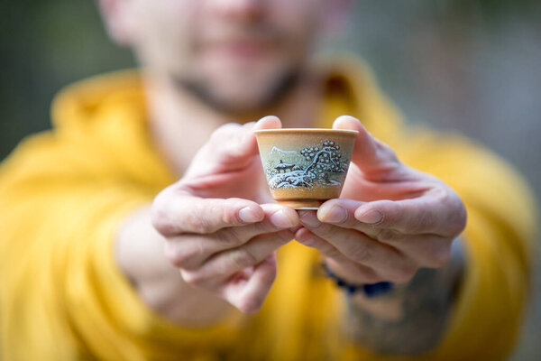 Outstretched Male Arms Hold Beautiful Chinese Tea Cup Royalty Free Stock Images