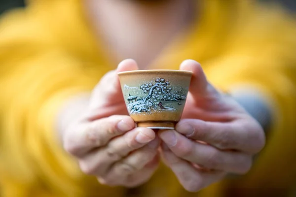 Outstretched Male Arms Hold Beautiful Chinese Tea Cup Stock Picture