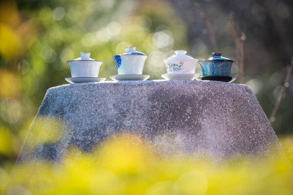 Four Gaiwans Chinese Ceremony Stand Side Side Large Rock Blurred Stock Photo