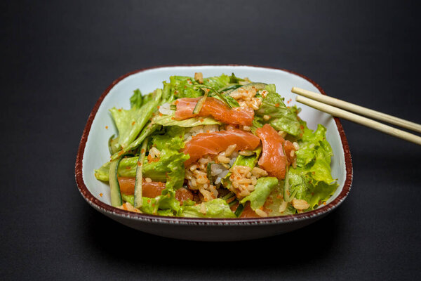 Asian Food Rice Raw Salmon Green Leaves Bowl Black Background Royalty Free Stock Photos