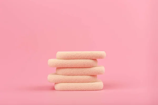 Gros plan de pile d'éponges de maquillage beige sur fond rose avec espace de copie — Photo