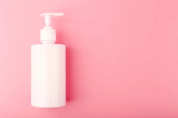 Top view of shower gel or intimate gel for woman in white tube on pink background with copy space — Stock Photo, Image
