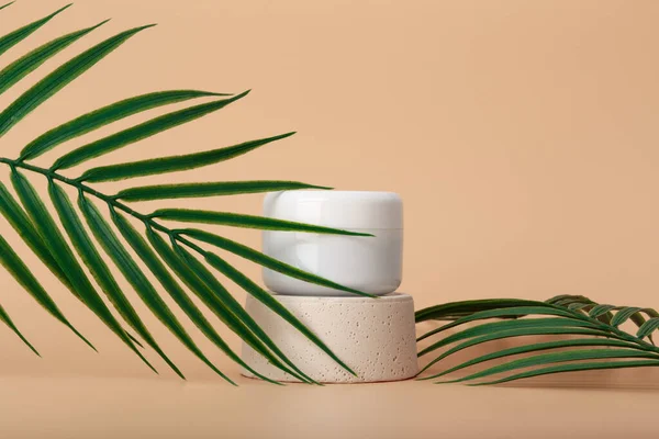 White Cosmetic Jar Podium Pastel Beige Background Decorated Palm Leaves — Stock Photo, Image