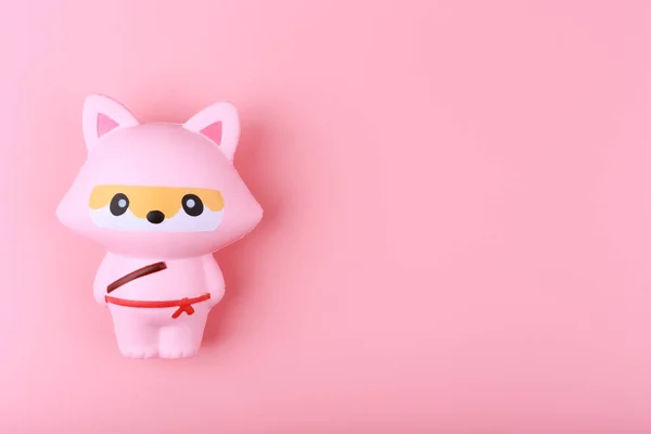 Trendy anti stress relaxing cute toy fox for squeezing on pink background with copy space — Stock Photo, Image