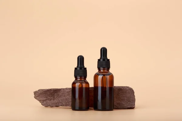 Two Skin Serum Bottles Next Natural Stone Beige Background Copy — Stock Photo, Image