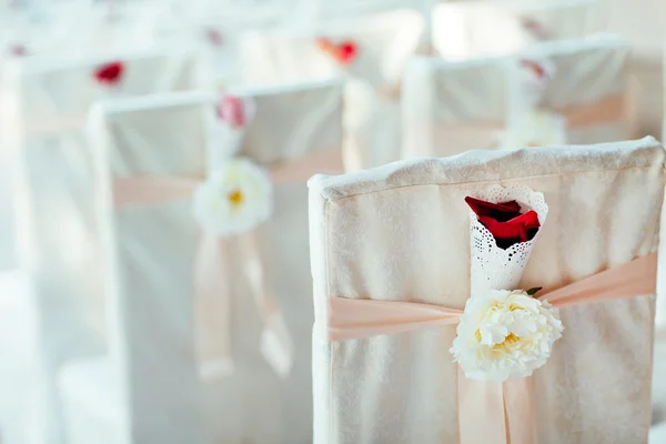 Wedding ceremony chairs. Floral arrangement at a wedding ceremony.