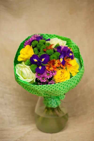 Beautiful bouquet of bright flowers in basket — Stock Photo, Image