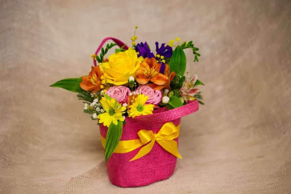 Beautiful bouquet of bright flowers in basket — Stock Photo, Image