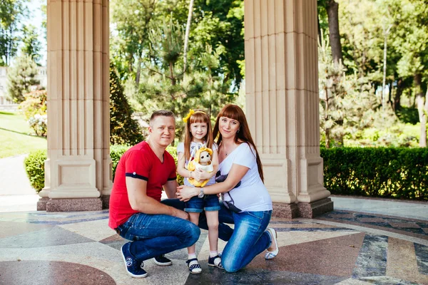 A young family, a pregnant mother, father, daughter — Stock Photo, Image