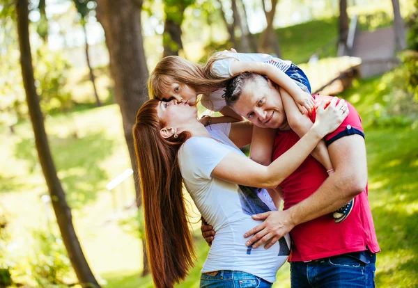 A young family, a pregnant mother, father, daughter — Stock Photo, Image