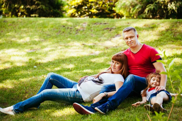 A young family, a pregnant mother, father, daughter — Stock Photo, Image