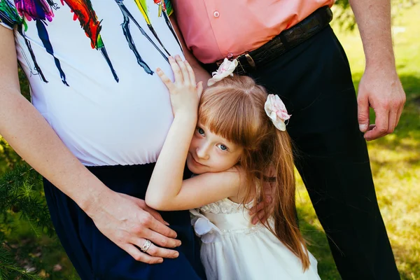 A young family, a pregnant mother, father, daughter — Stock Photo, Image