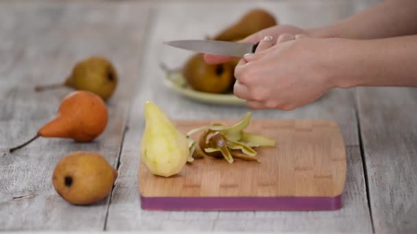 女性はテーブルの上にデザートの梨を剥離 — ストック動画