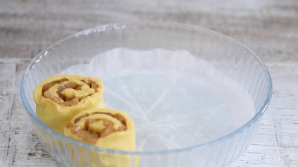 Baker armutlu çörekleri cam pişirme formuna koydu. Kadınlar hamur tatlısı yapar.. — Stok video