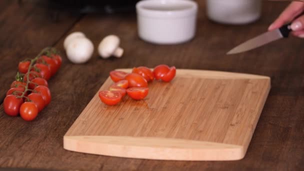 Female Hands Cut Cherry Tomatoes On Halved With a Knife. — Stock Video