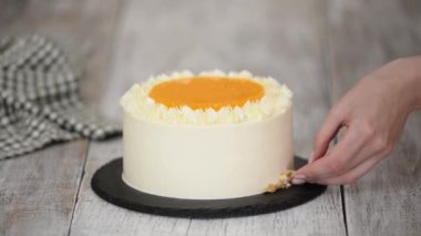 Kadın havuçlu keki doğranmış cevizle süslüyor..