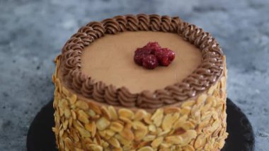 Çikolatalı pastayı kirazla süslemek. Pasta şefi ev yapımı kek pişiriyor..