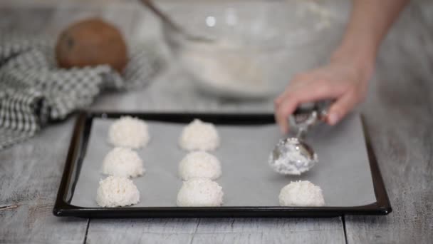 Woman preparing cookies at the kitchen, making coconut macaroons. — Stock Video