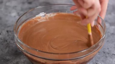 Chocolate mousse being mixed in bowl.