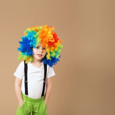 Happy clown boy with large colorful wig clipart