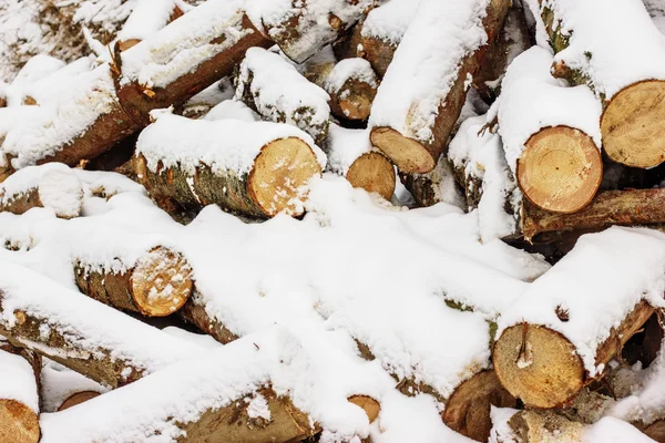 古い木製の背景に雪に覆われた薪のスタック 木の部分 木の背景テクスチャまたはマントルピース暖炉の屋外に保管チョップ — ストック写真